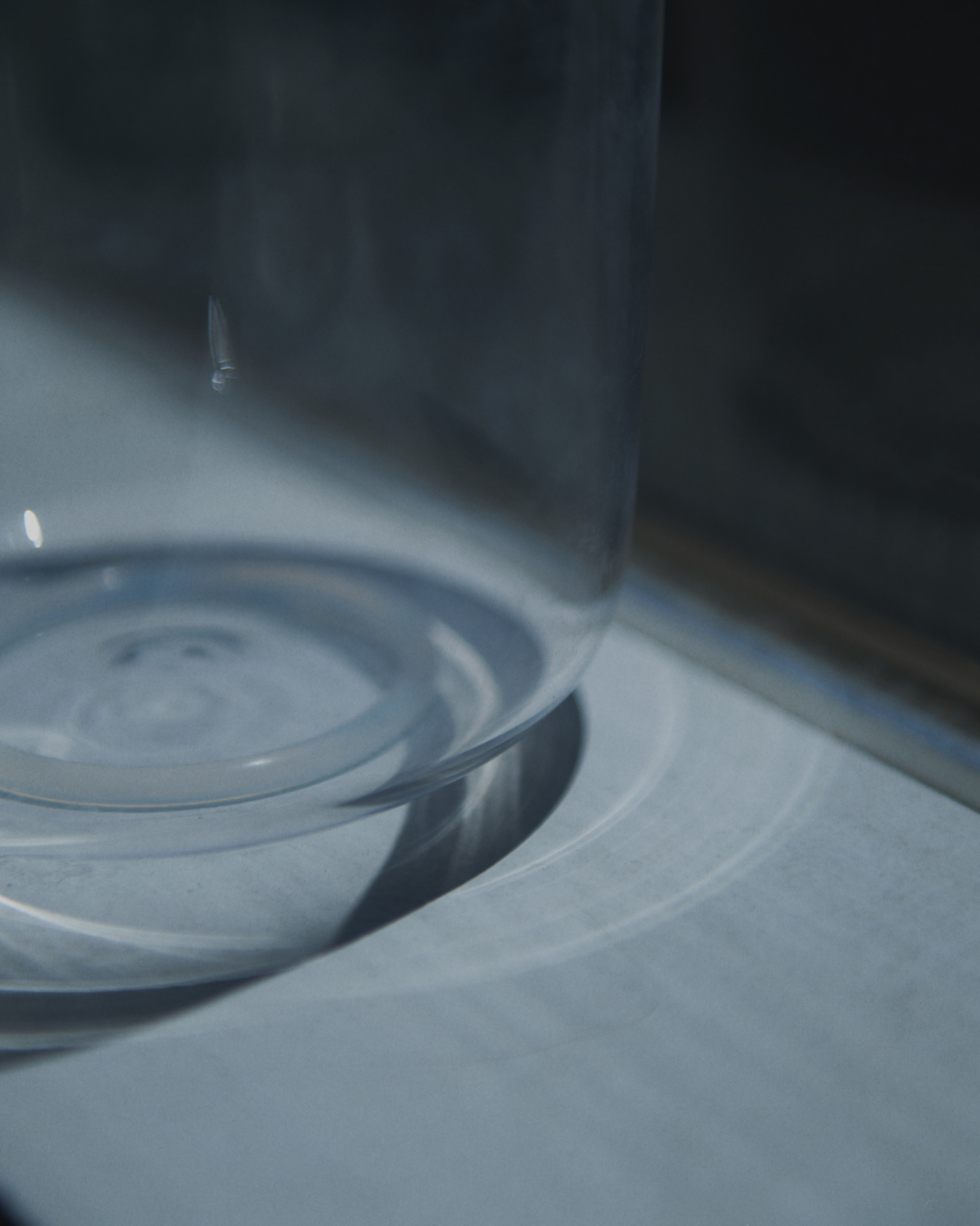 Glass vessel resting in soft reflected daylight